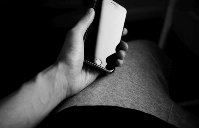 A hand holding an iPhone